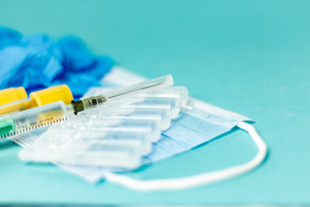 Medical vials for injection, syringe for injection, mask gloves on a blue background. Admission vaccination, flu shotの写真素材
