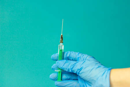 Medical vials for injection, syringe for injection, mask gloves on a blue background. Admission vaccination, flu shot.の写真素材