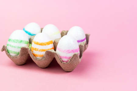 Colorful Easter eggs on a pink background. Copy space. Celebrating Easter.の写真素材