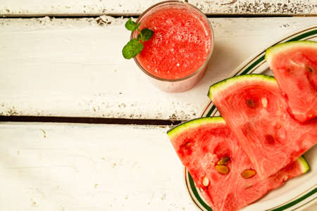 Watermelon drink and abuza slices. Watermelon and gin punch on the table in a summer bar, party. Summer refreshing drink. Copy spaceの写真素材
