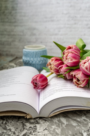 Pink tulips, an open book and a mug of freshly brewed coffee or tea. Spring set. Flatley layout.の写真素材