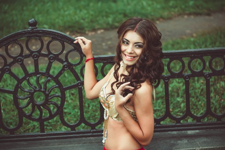 girl in swimsuit smiling at the iron fenceの写真素材