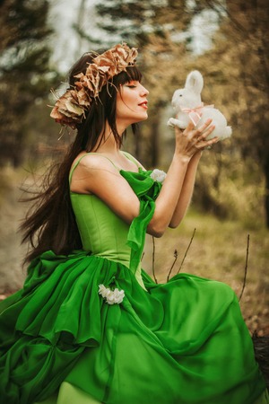 the girl in the woods with a toy in the hands ofの写真素材