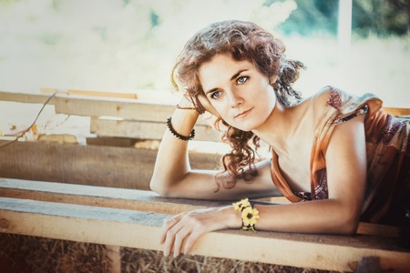 Happy beautiful girl lying on wooden board.の写真素材