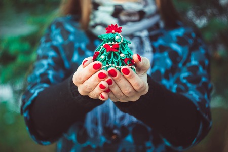 Christmas tree in hand isolated on white backgroundの写真素材