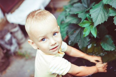 the kid is happy playing with water outdoorsの写真素材