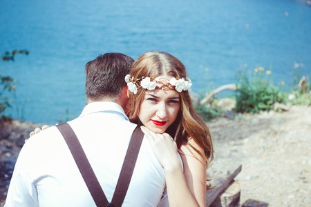 couple sitting by the lake huggingの写真素材