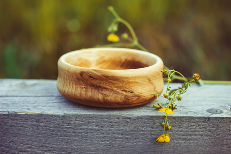 a wooden bowl is outdoors in a treeの写真素材