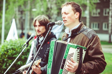 Big public market day in town. Singer and musician performing as street musicianの写真素材