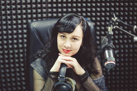 Female reporter doing a survey with microphone and clipboardの写真素材
