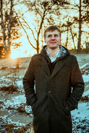 Portrait of happy man smiling outdoors during cold winter dayの写真素材