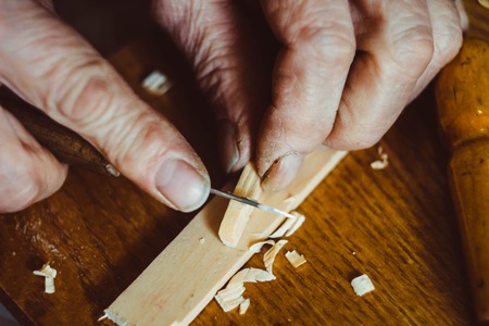 the hands of the craftsmen carved wooden productの写真素材