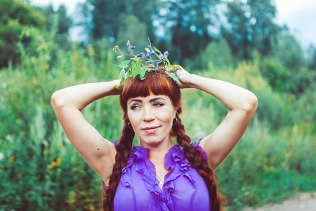 A young woman in a wreath of yellow flowersの写真素材
