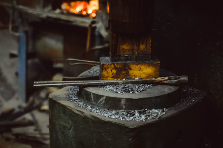 blacksmith's tools lie on the surface in the forgeの写真素材