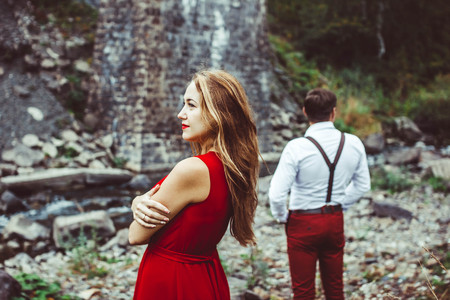 Couple standing in the nature, the girl in frontの写真素材