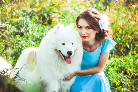 Woman in a dress in nature with a dogの写真素材