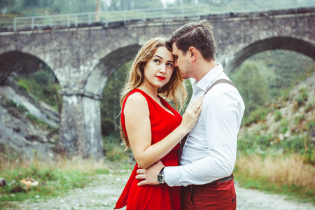 Lovers are standing at the bridge looking at each otherの写真素材