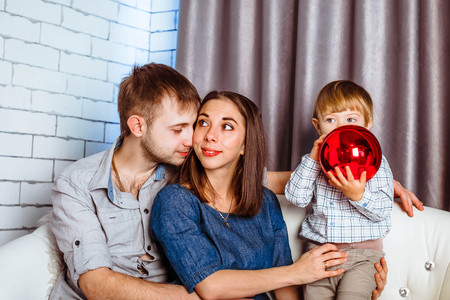 Young family watching TV together at home and having fun together.の写真素材
