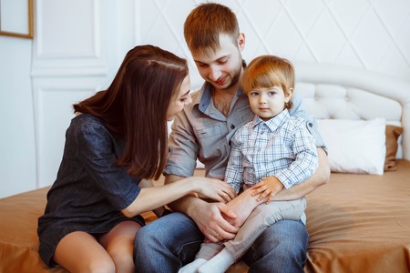 loving mother watching daughter playing with toyの写真素材