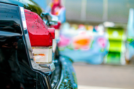 Retro car rear lantern on city streetの写真素材