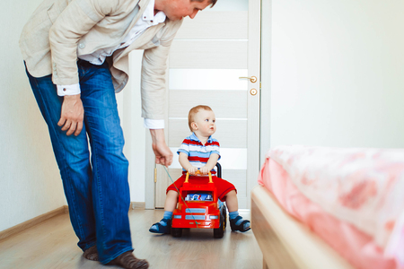 A little child, driving around the houseの写真素材