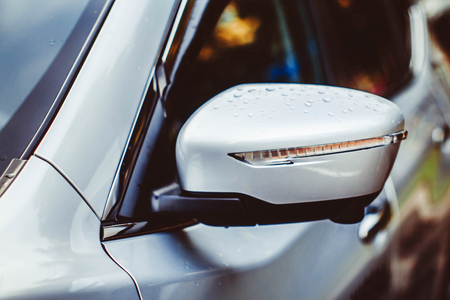 Car mirror lateral after rain on the streetの写真素材