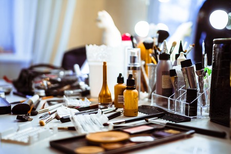 Set of make up brushes, accessories and color palettes laid out on a desk at the beautician saloon.の写真素材