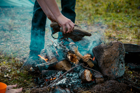 The camp fire on which to dry Hiking boots and preparing food in a potの写真素材