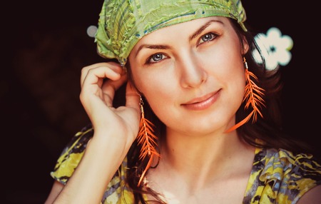 Beautiful young woman hippie posing outdoor looking at cameraの写真素材
