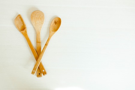 Kitchen wooden utensils on a white table. View from above with copy space.の写真素材