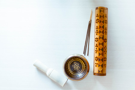 The statuette of the Buddha's blessing on a light background with Aromatic sticks.の写真素材