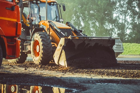 Russia, Novokuzneck, 14.08.2017: Laying asphalt into the city with a rollerのeditorial素材