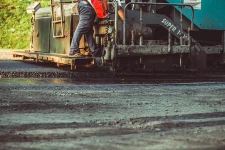 Russia, Novokuzneck, 14.08.2017: Laying asphalt into the city with a rollerのeditorial素材
