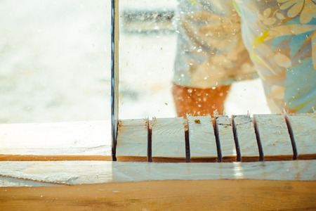 Man with a chainsaw cutting a tree for constructionの写真素材