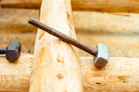 the hammer lies on the beam of an unfinished houseの写真素材