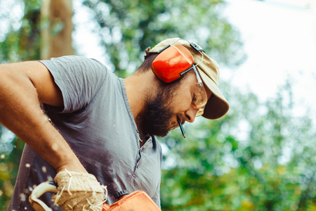 industry, building, technology and people concept - male builder in hardhat with walkie talkie or...