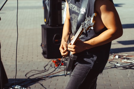 Novokuzneck, Russia, 27.06.2017 closeup of teenager playing electric guitar in the streetのeditorial素材
