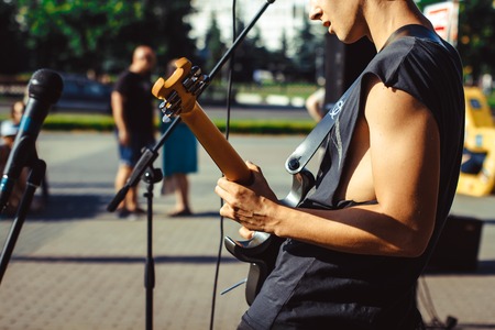 Novokuzneck, Russia, 27.06.2017 closeup of teenager playing electric guitar in the streetのeditorial素材