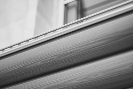 Installation on facade of the house panels beige vinyl siding