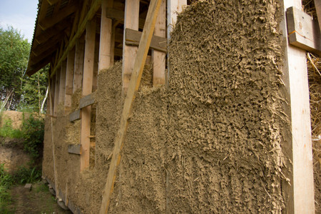 unfinished frame wooden house, plaster from clayの写真素材