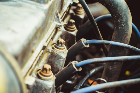 A close up shot of the engine of an old car