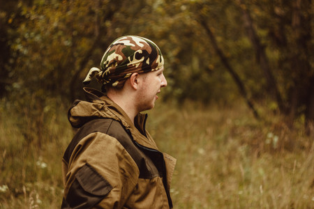 man military bandana standing in the woodsの写真素材