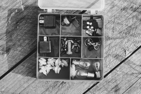 Accessories for needlework in a box with cells. Stuff. Small depth of sharpness. Horizontal format. Indoors. Without people. Color. Photo.の写真素材