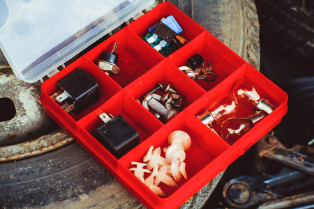 Accessories for needlework in a box with cells. Stuff. Small depth of sharpness. Horizontal format. Indoors. Without people. Color. Photo.の写真素材