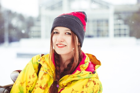 woman in jacket standing on the street in winterの写真素材