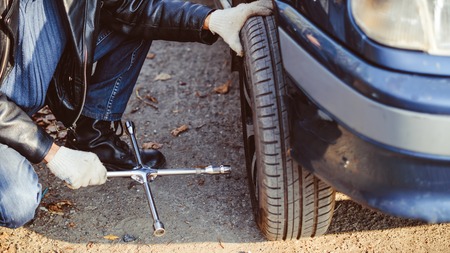 Change a flat car tire on road with Tire maintenance, damaged car tyreの写真素材