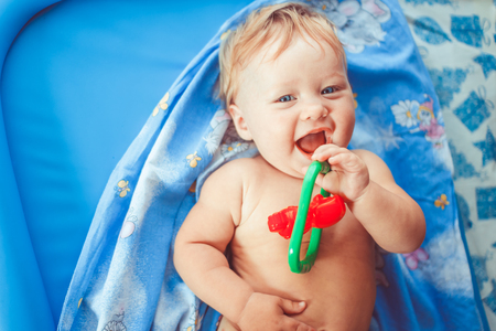 Positive child lying on bed, overhead viewの写真素材