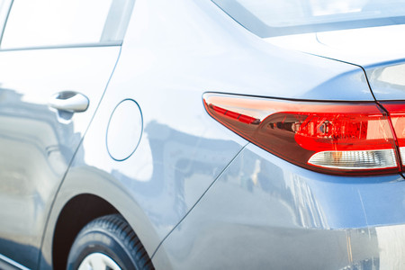 Modern blue car tail light in wet rain drop. Red modern car back lightの写真素材