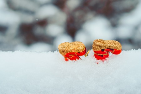 Christmas Boots Background. New Year Toy for christmas tree - shoes boots with fir branches, candy cane and cinnamon sticks on dark stone background. Holiday card. Copy spaceの写真素材