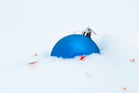 Blue Christmas tree decoration on snow backgroundの写真素材